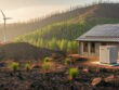 Clean energy systems, including solar panels and a battery storage unit, in a wildfire-damaged western landscape showing new regrowth and community rebuilding.